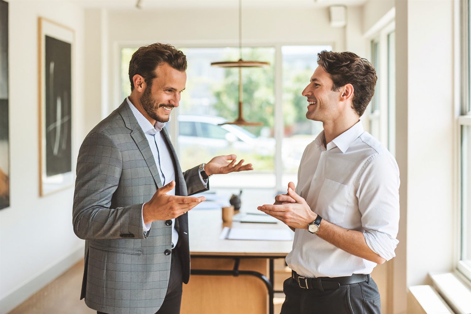 Two business professionals in conversation in a small business workspace.